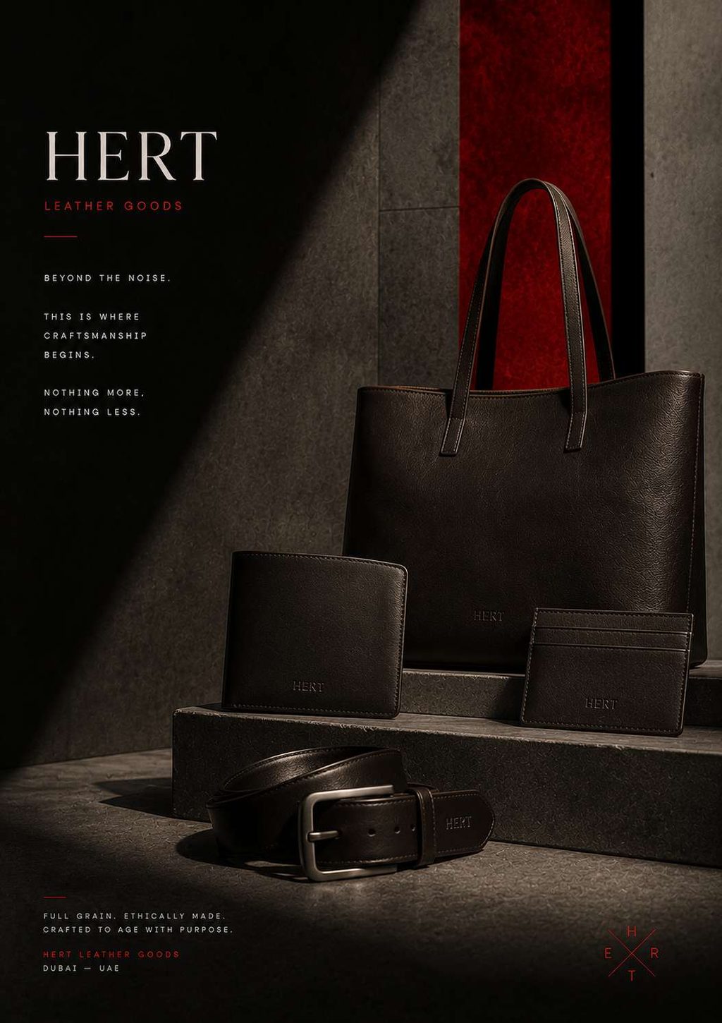 Leather goods family — tote, belt, wallet and pouch on concrete plinths.